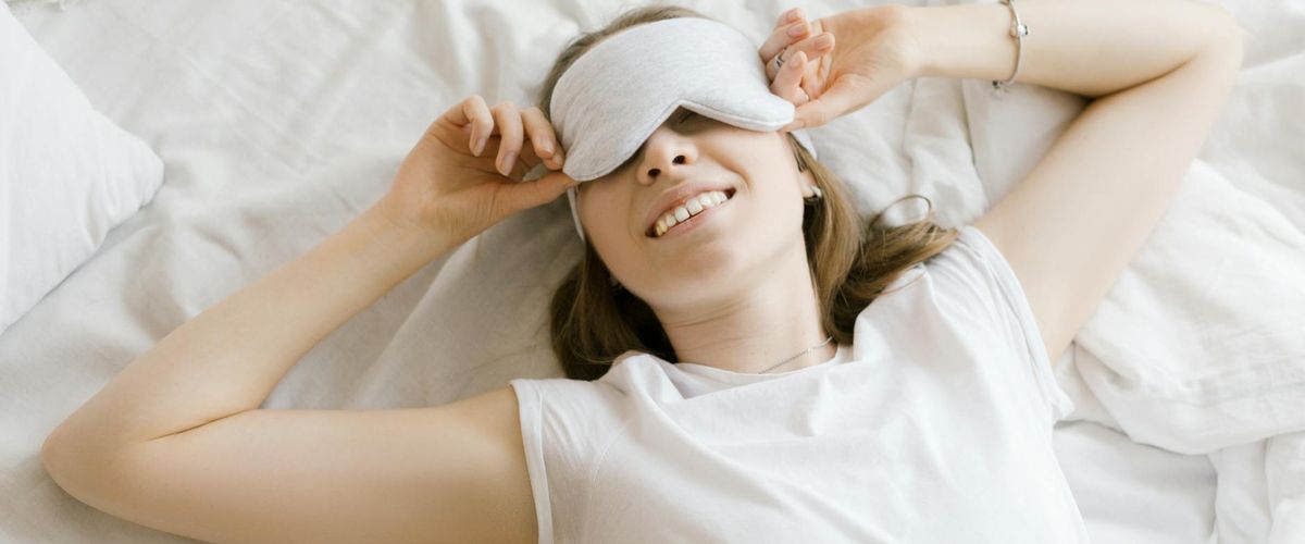 A cozy and quiet corner of a room with a yoga mat, a plant, and soft morning light.