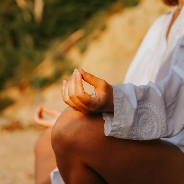 Close-up of hands in a meditative mudra gesture, symbolizing mindfulness.